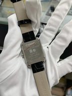 Chanel watch with black leather strap, silver back plate engraved “SWISS MADE”.