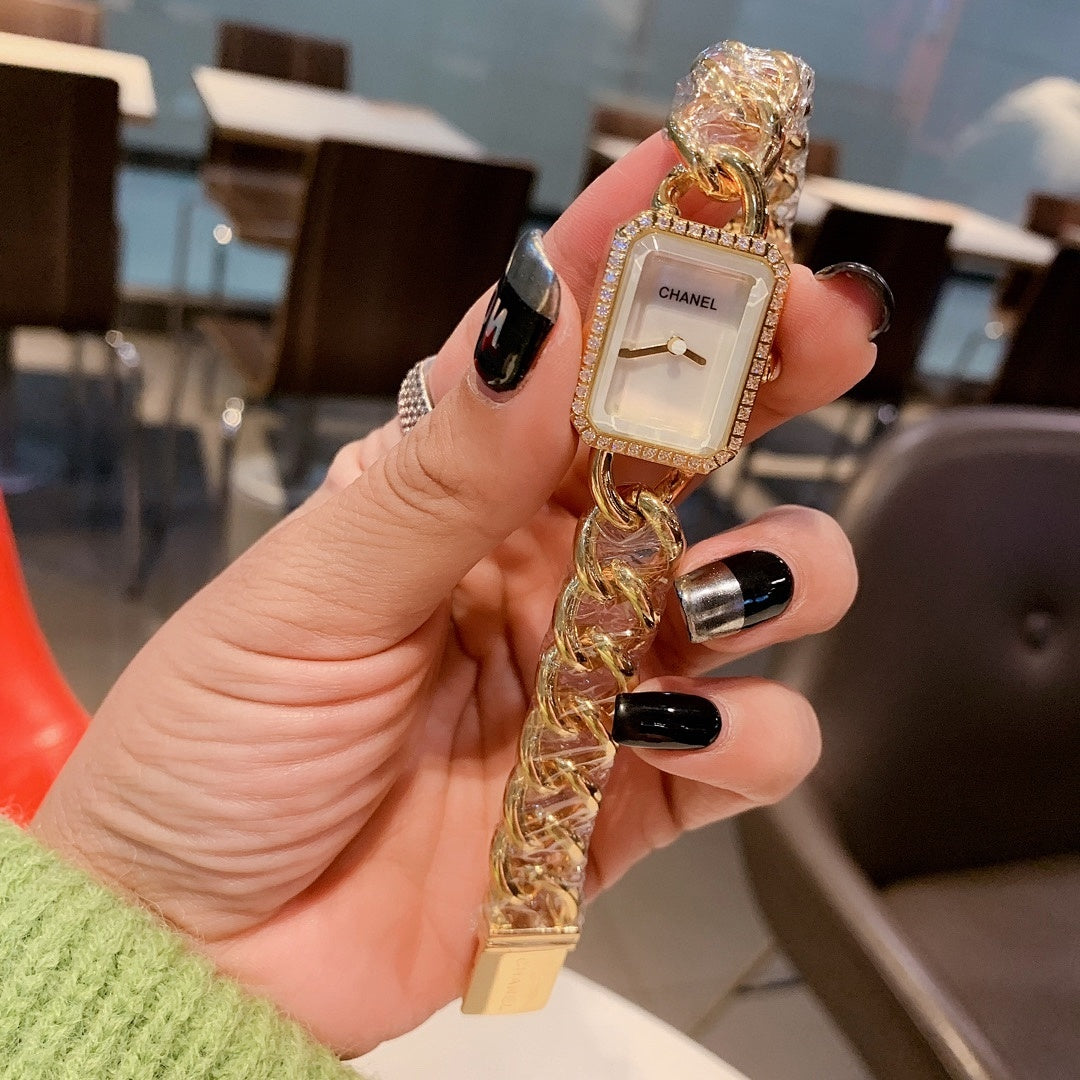 Gold Chanel watch with square white dial and chunky chain link strap