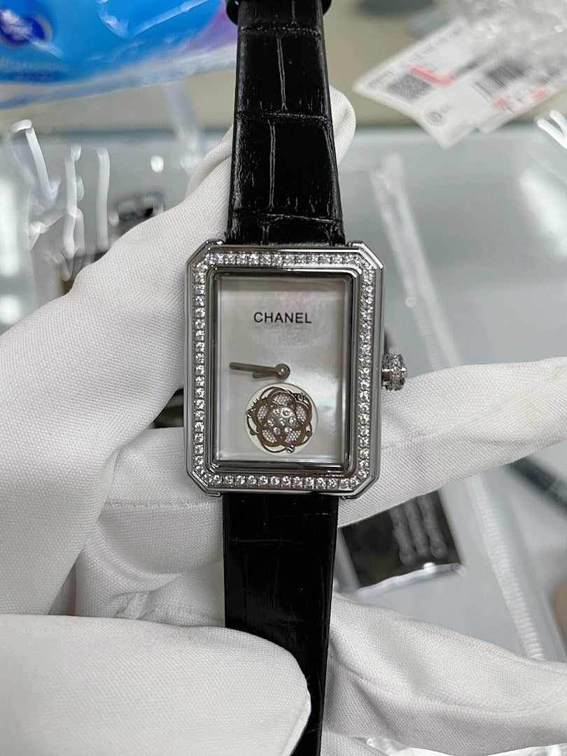 Chanel watch with black leather strap, square silver case, rhinestone bezel