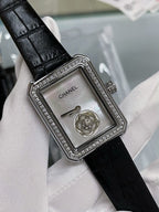 Square watch face with black leather strap, silver rhinestone bezel, crown on right