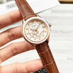 Chanel watch with brown leather strap and gold-tone bezel, round floral butterfly dial