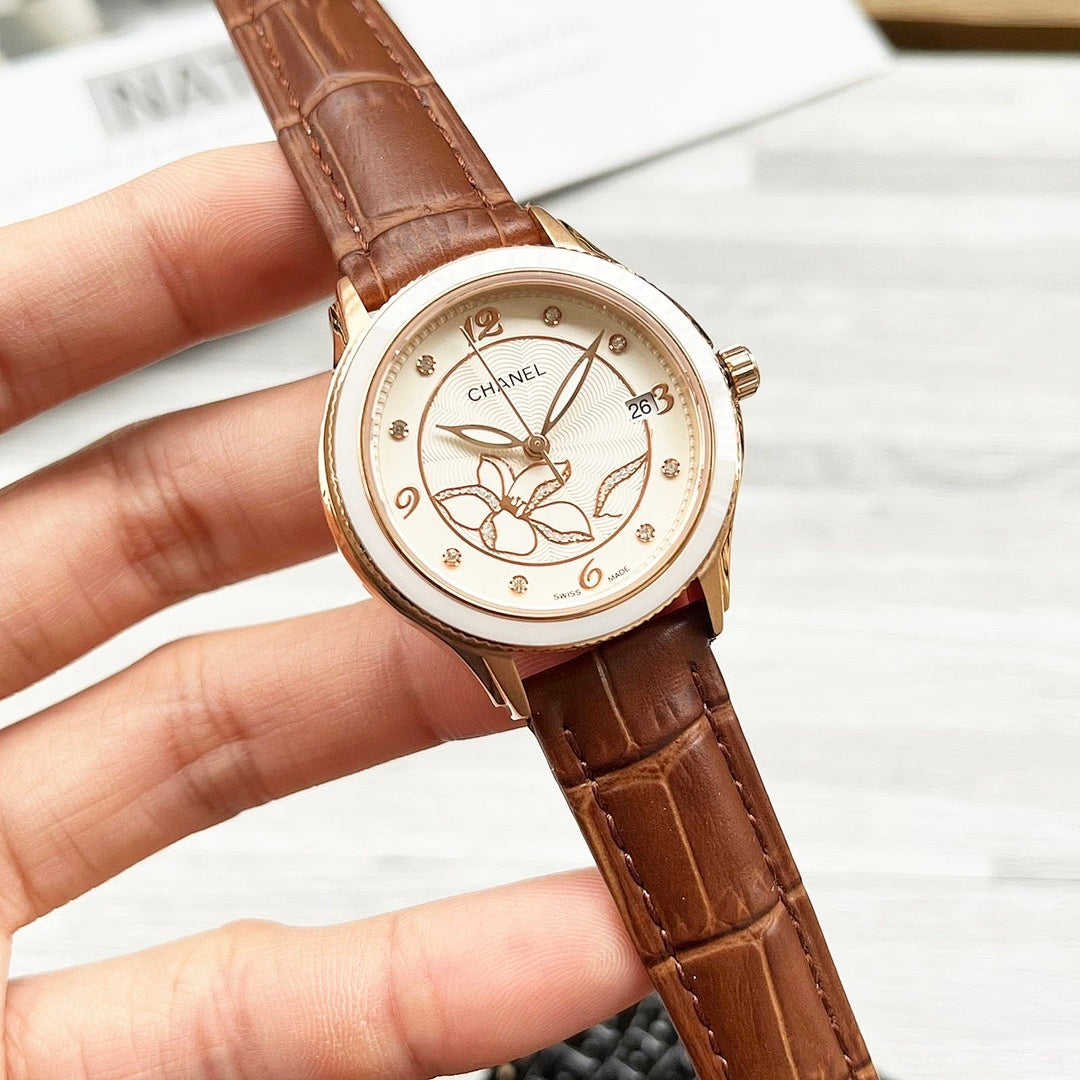 Chanel watch with brown leather strap and gold-tone bezel, round floral butterfly dial