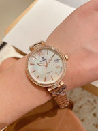 Rose-gold Chanel wrist watch with rhinestone bezel, round white dial and Roman numerals