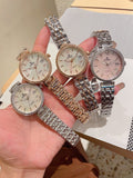 Set of three Chanel wrist watches with metal link bracelets, round white dials