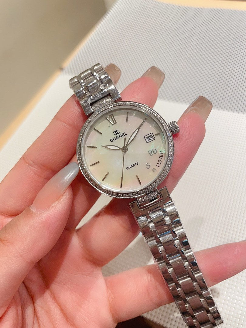 Silver-tone Chanel wrist watch with metal bracelet, round white dial and bezel stones