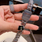 Chanel watch with silver chain and dark dial, held in hand