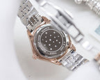 Metal analog wristwatch with engraved case back and patterned bezel