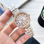Rose-gold CHANEL round watch with jeweled bezel, white dial, and two-tone metal bracelet