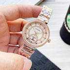 Rose-gold CHANEL round watch with jeweled bezel, white dial with red markers and metal bracelet