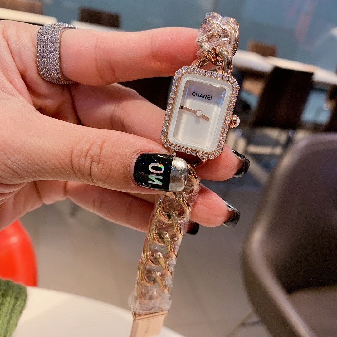 Rectangular black-dial watch with rose-gold tone chain bracelet and jeweled frame