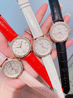 Chanel watch set with white, black, and red straps, round rose-gold dials