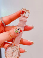 Chanel watch with pale pink leather strap, studded with small multicolor details