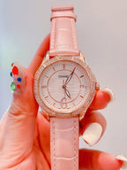 Chanel watch with pale pink strap and rose-gold bezel, round white dial