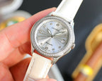 Chanel watch with round silver dial, jeweled bezel, and white leather strap