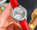 Chanel watch with round silver face, jeweled bezel, and red leather strap