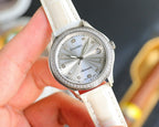 Chanel watch with round silver dial, jeweled bezel, and white leather strap