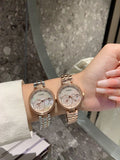 Chanel round wristwatch set with rose-gold and silver-tone metal links, white dial on wrist