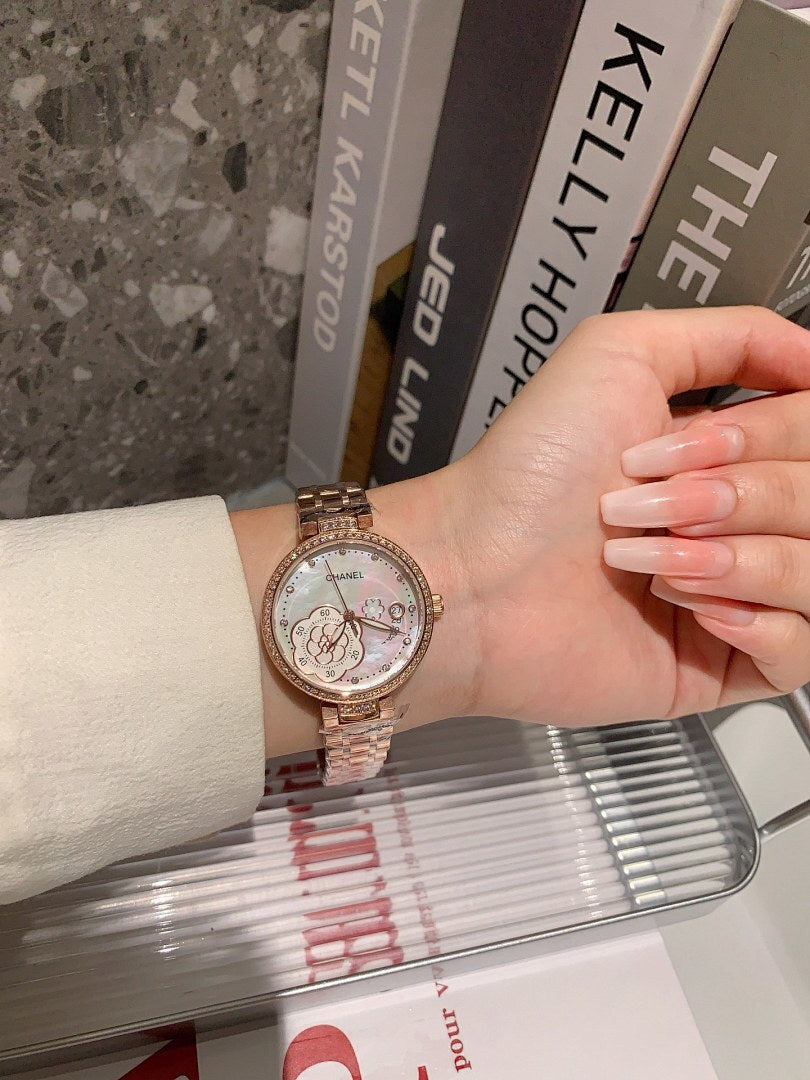 Chanel round wristwatch on wrist with rose-gold tone bracelet and white dial, box in view