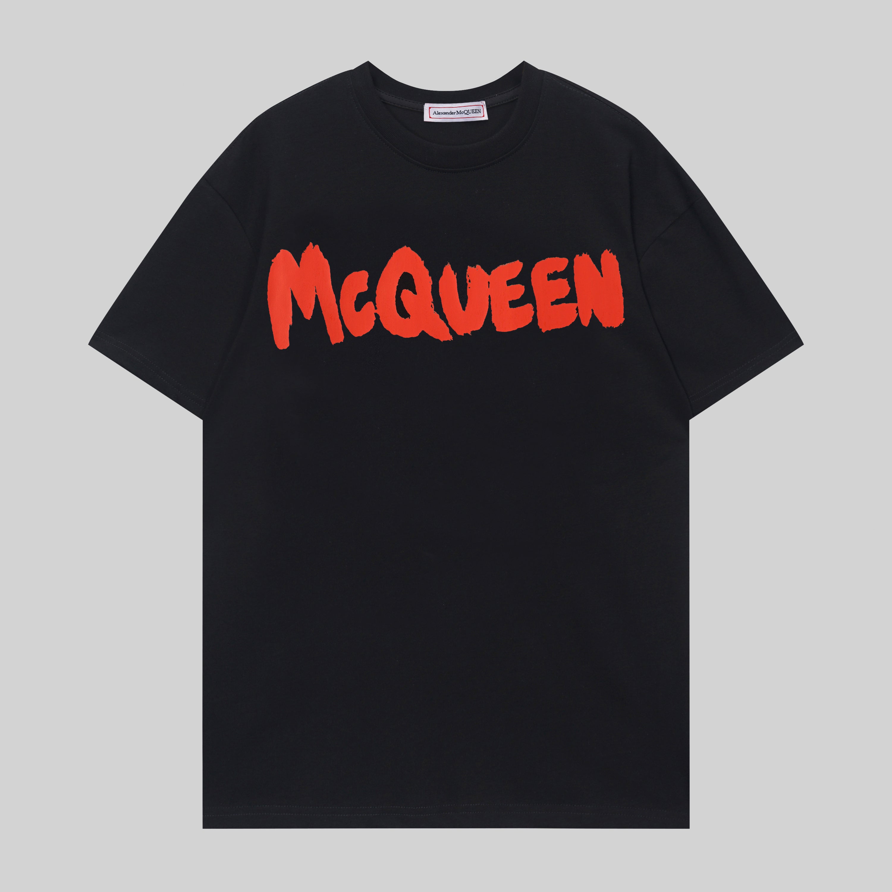 Alexander McQueen black T-shirt with red McQueen logo across chest