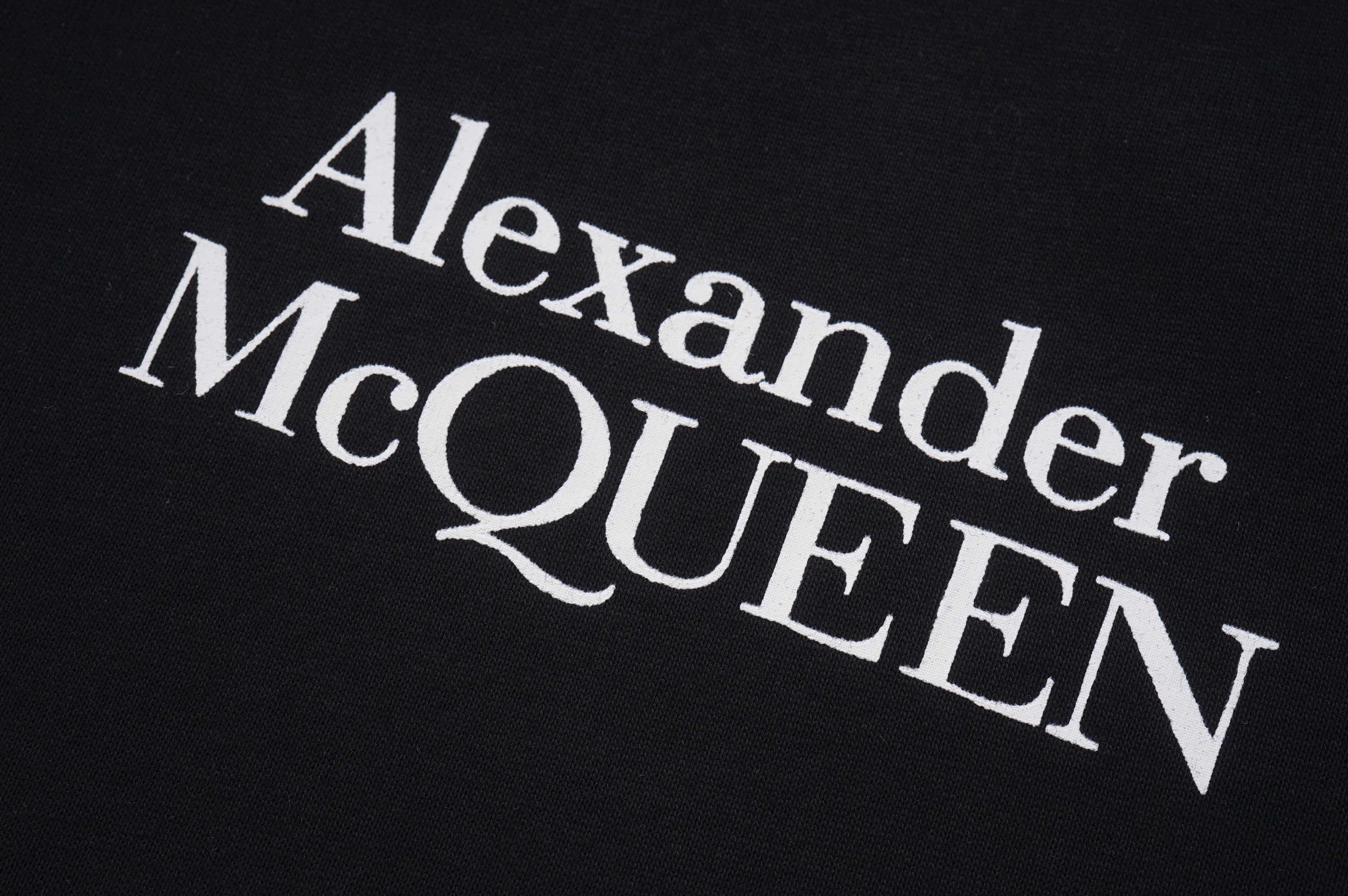 Alexander McQueen logo print on dark T-shirt fabric