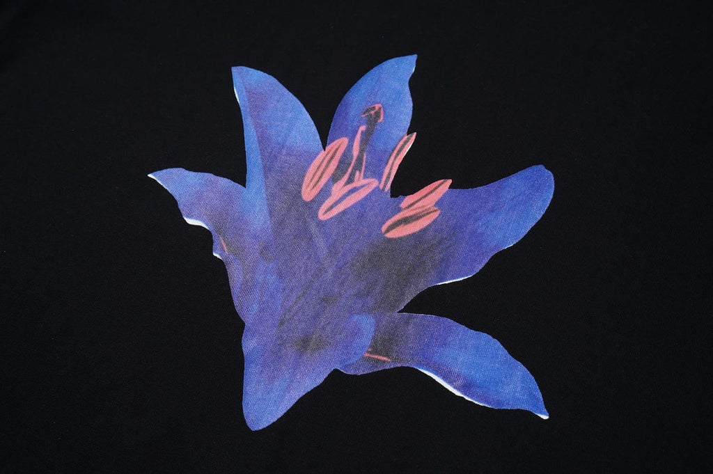 Black cotton T-shirt front with large blue flower graphic and pink accents
