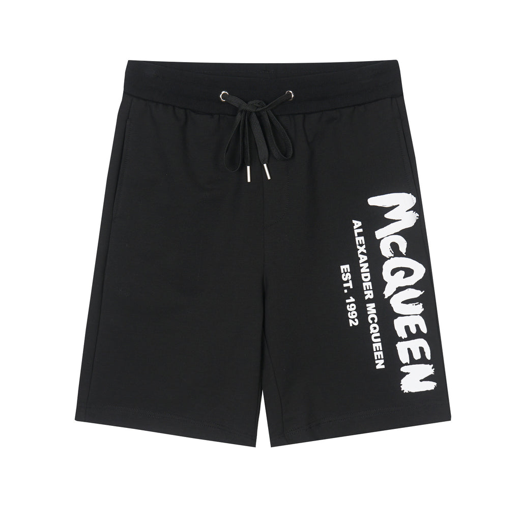 Drawstring shorts in black with white McQueen logo on right leg