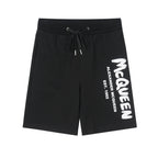 Drawstring shorts in black with white McQueen logo on right leg