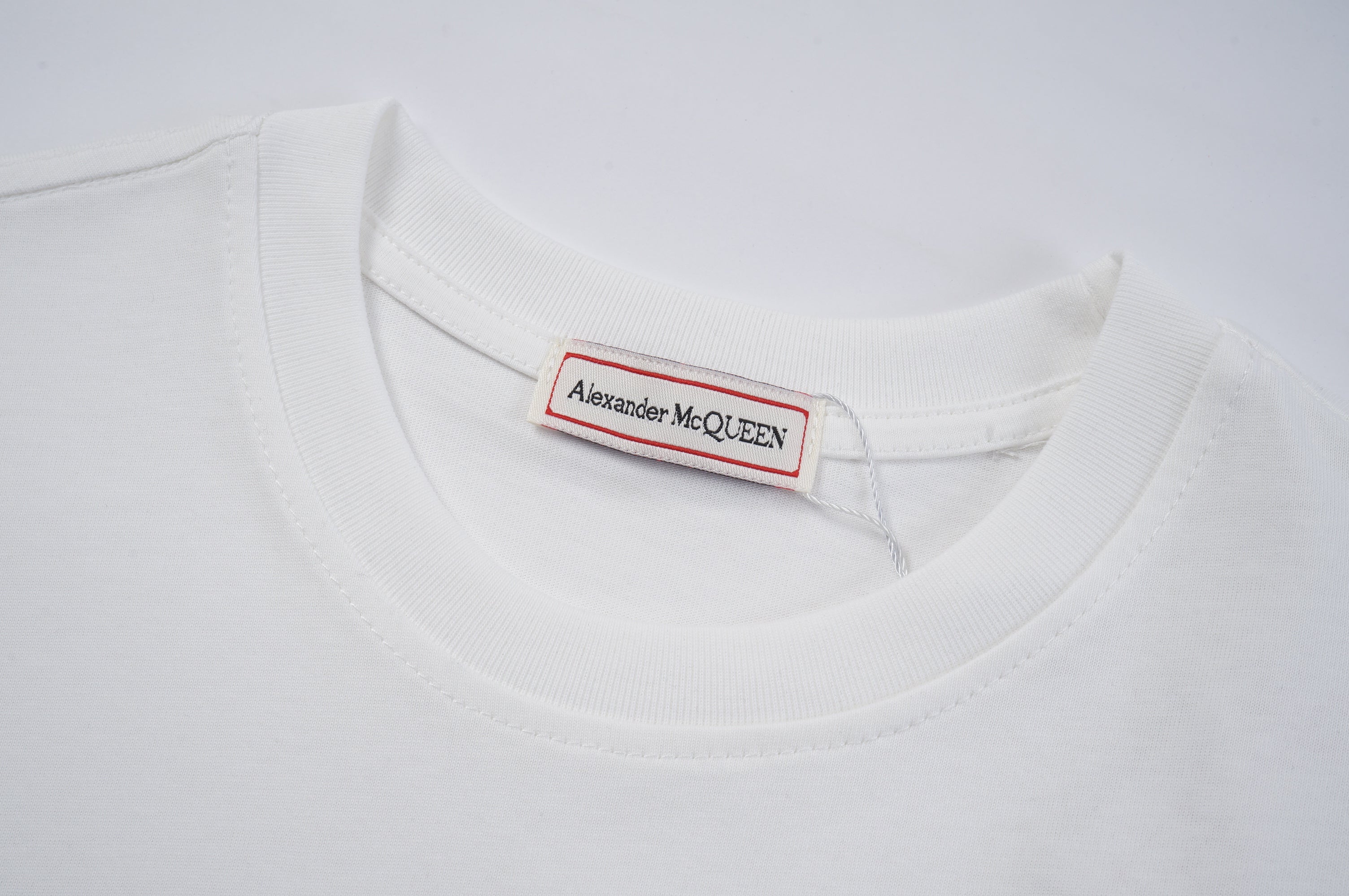 White T-shirt neckline with Alexander McQueen label tag