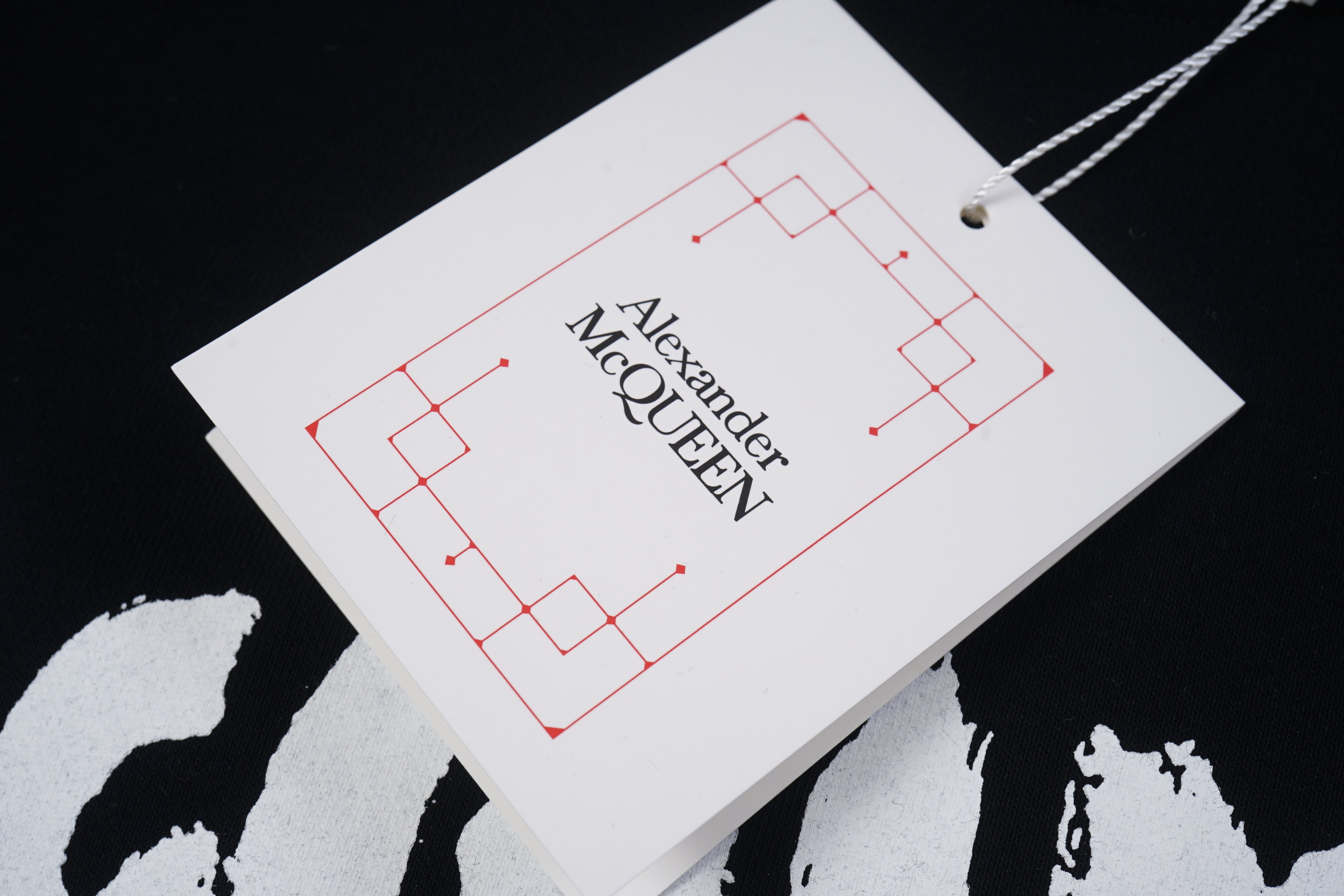 Alexander McQueen hang tag with logo text