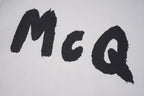 Alexander McQueen T-shirt close-up, large black McQ letters on light fabric