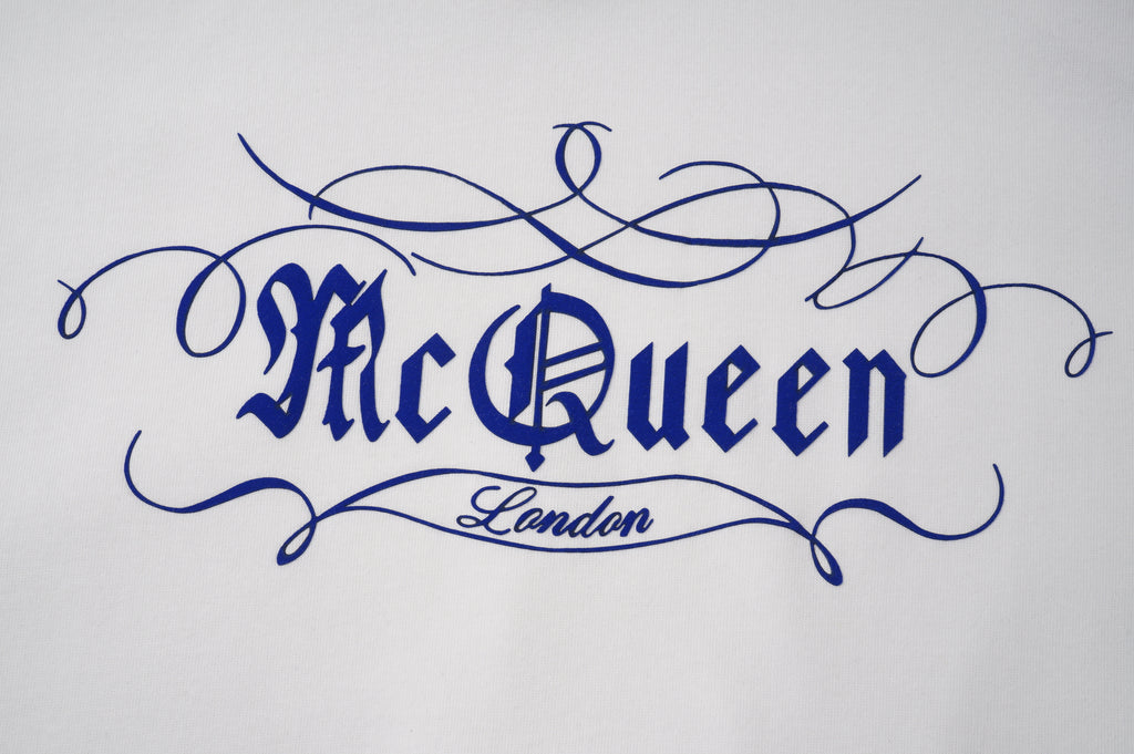 Light hoodie fabric with blue embroidered 'McQueen' logo and 'London' detail