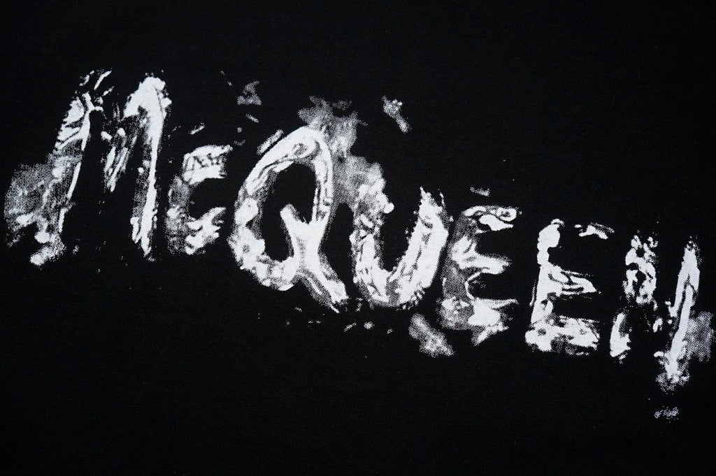 Black crewneck T-shirt with large distressed McQUEEN wordmark print