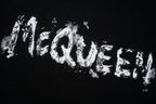 Black crewneck T-shirt with large distressed McQUEEN wordmark print