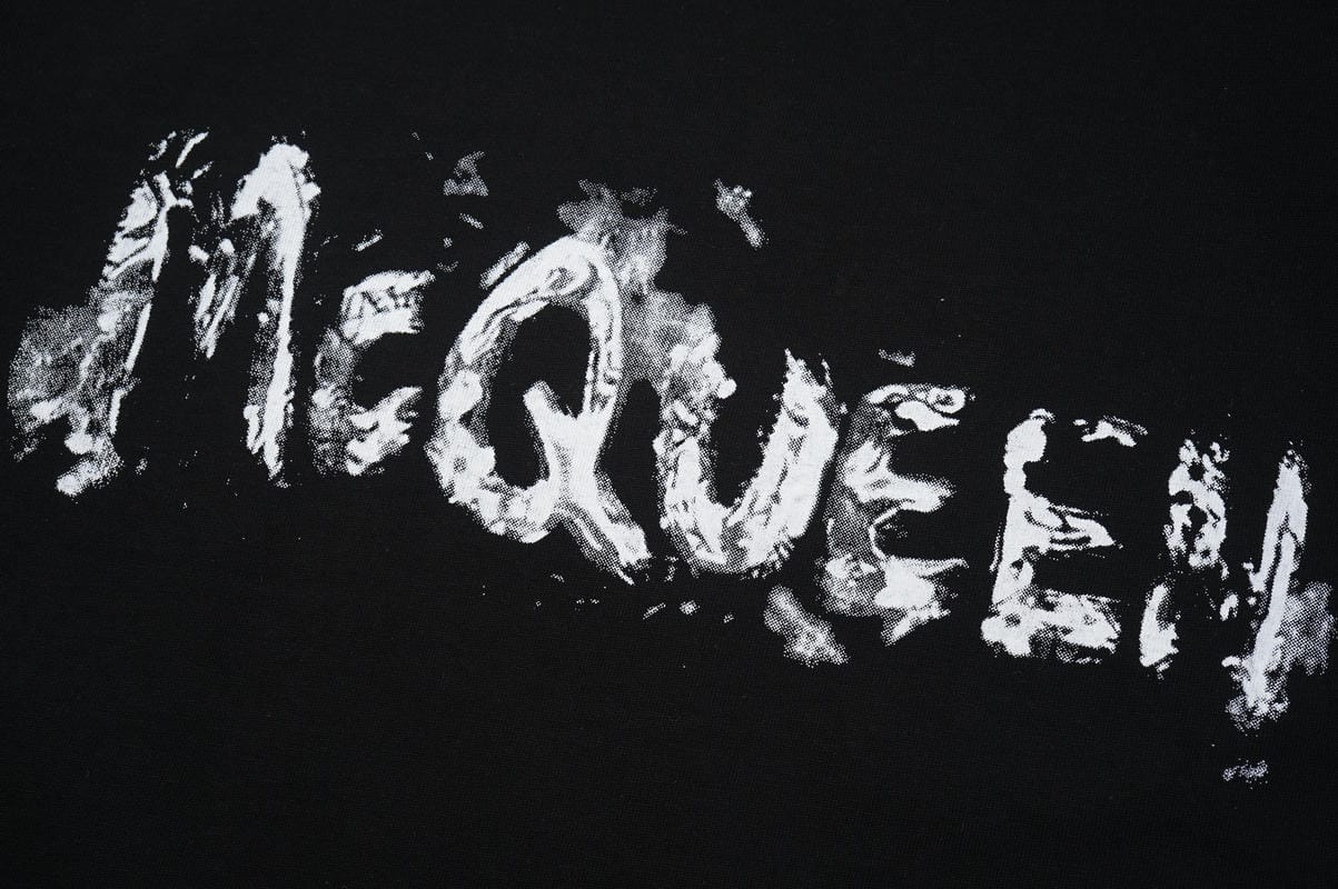 Black crewneck T-shirt with large distressed McQUEEN wordmark print