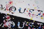 Alexander McQueen T-shirt fabric close-up with colorful splatter logo print