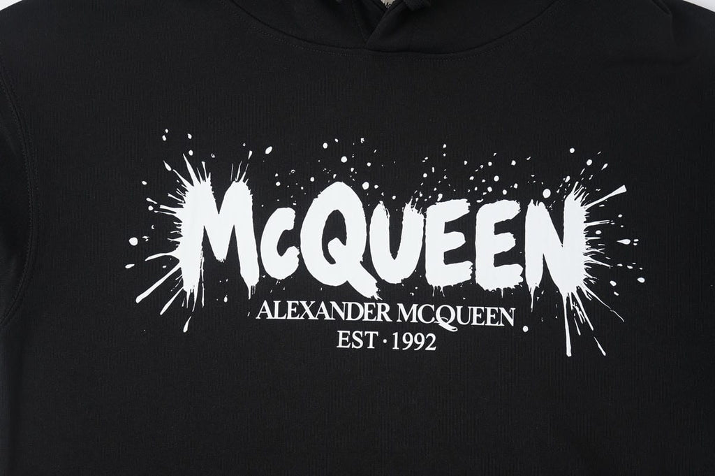 Black Alexander McQueen hoodie with large front logo print and drawstring hood.