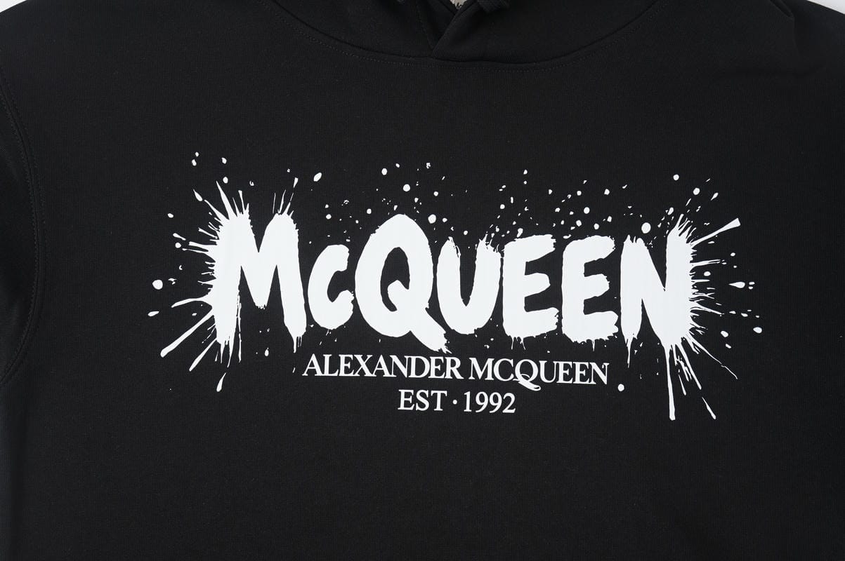 Black Alexander McQueen hoodie with large front logo print and drawstring hood.