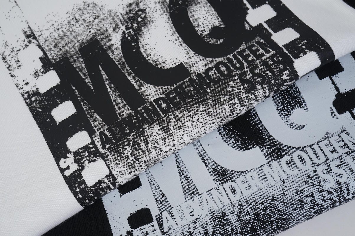 Close-up of MCQ logo graphic on cotton T-shirt front