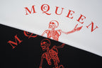 Alexander McQueen T-shirt graphic close-up, red skeleton on white and black fabric