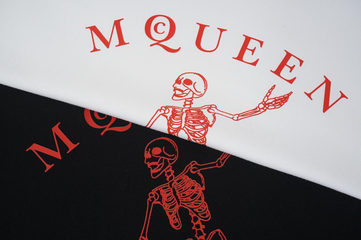 Alexander McQueen T-shirt graphic close-up, red skeleton on white and black fabric