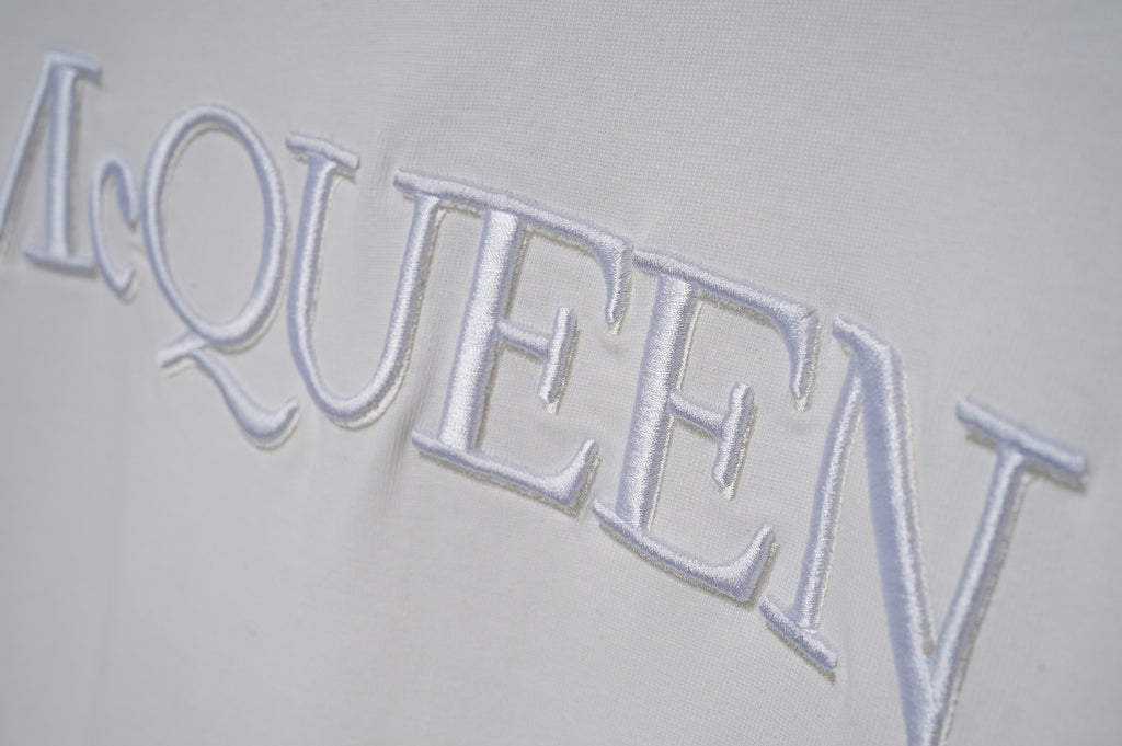 White short-sleeve T-shirt close-up of McQUEEN logo lettering