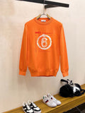 Orange crewneck sweatshirt with long sleeves and “6” graphic print on chest