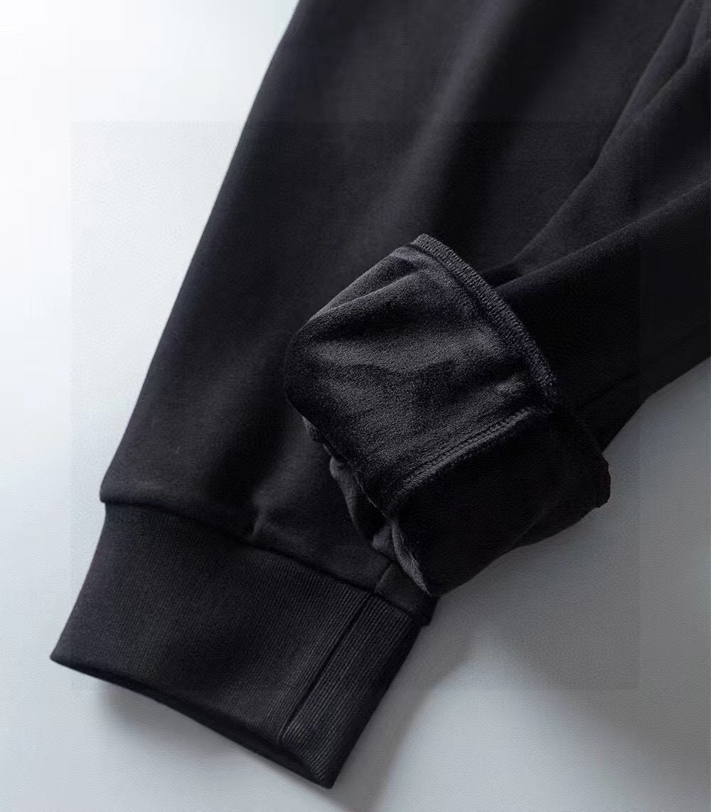Dark long-sleeve top with ribbed cuff and folded sleeve detail