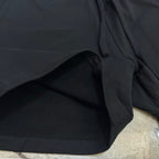 Black shorts fabric close-up with stitched drawstring waist