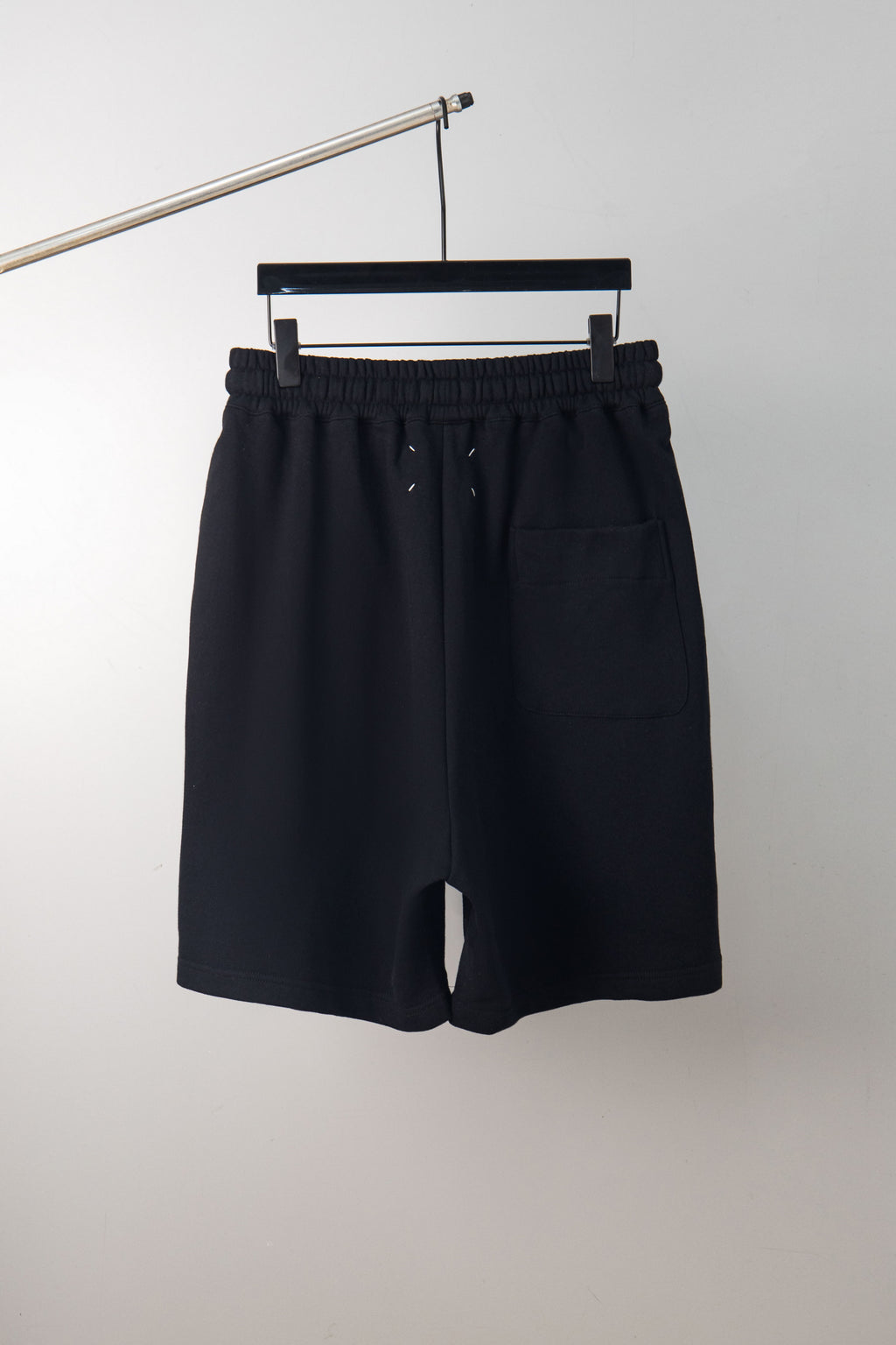 Black shorts with elastic waistband and drawstring; no graphic visible