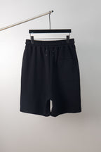 Black shorts with elastic waistband and drawstring; no graphic visible