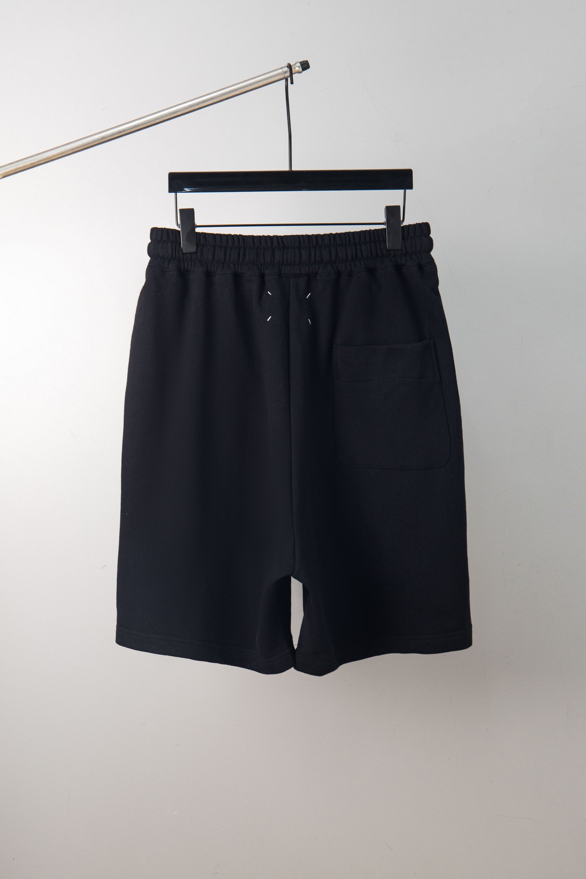 Black shorts with elastic waistband and drawstring; no graphic visible
