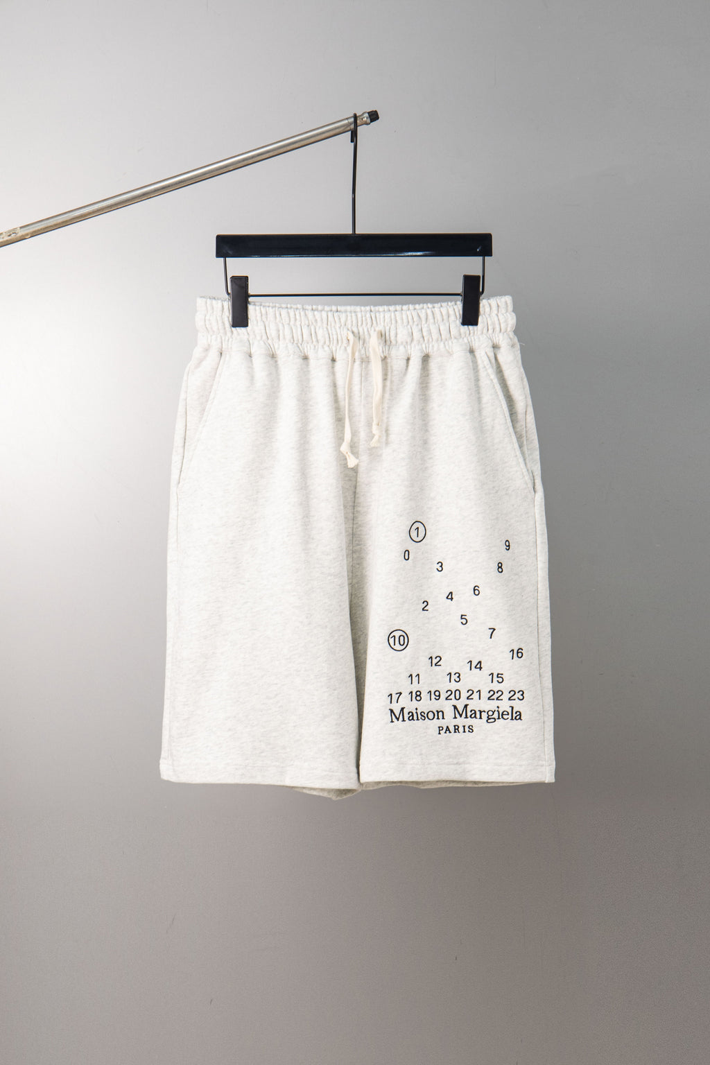 White drawstring shorts with elastic waistband and number chart graphic