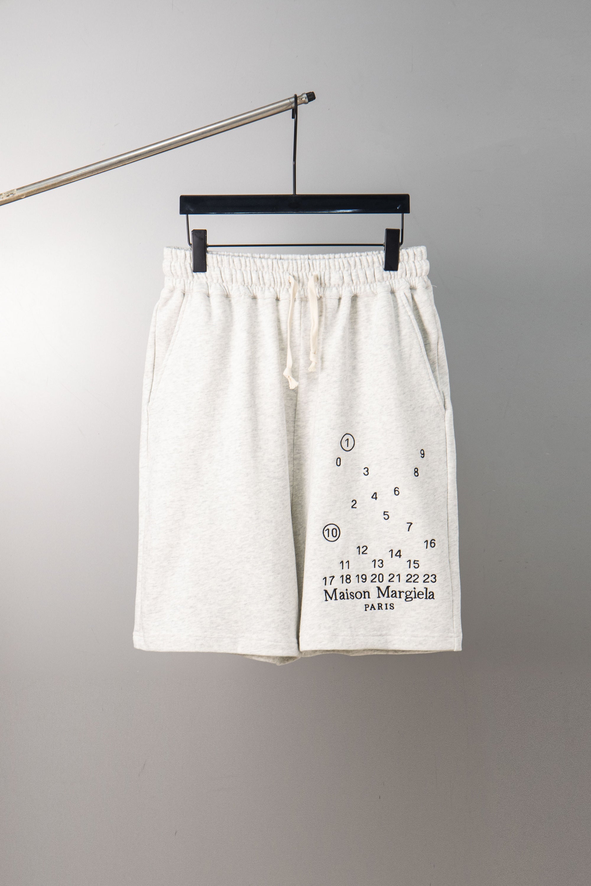 White drawstring shorts with elastic waistband and number chart graphic