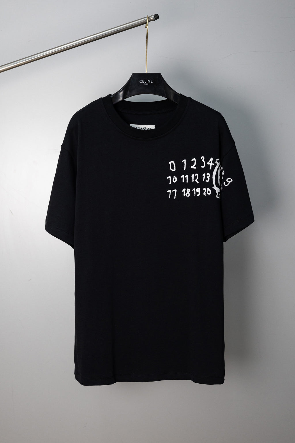Black crew-neck T-shirt with white number graphic on chest